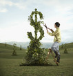 Man pruning dollar sign tree