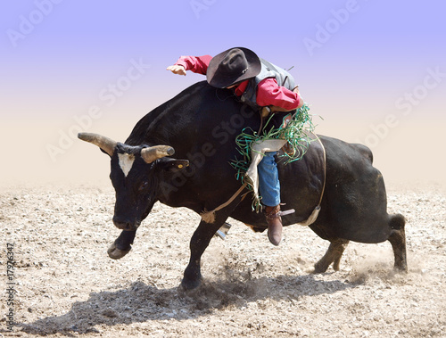 Photo: Cowboy Riding a Bull Cowboy Riding a Bull