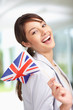 Happy young woman with a Great Britain flag