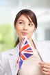 Pretty young female looking away , with a british flag