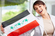 Lovely young woman displaying an Iraqi flag