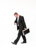 Walking businessman, looking at a watch.