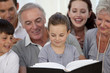 Close-up of family looking at a photograph album Close-up of family looking at a photograph album