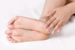 Applying cream to ankle