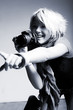 Young beautiful woman taking a photo with a digital camera