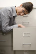 Photo: Woman searching in cabinet Woman searching in cabinet
