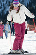 Young woman in snow with skis