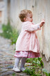 Small cute girl standing near old wall and painting graffiti Small cute girl standing near old wall and painting graffiti