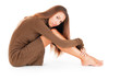 Thoughtful woman embracing her legs Thoughtful woman embracing her legs
