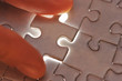 Photo: Hand placing missing puzzle piece Hand placing missing puzzle piece