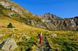 lady trekker looking at mountain landscape panorama
