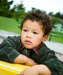 Pensive Little Boy in the Park