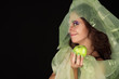 Cunning witch with green apple smiling