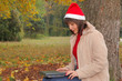 Christmas time - female santa with a laptop