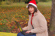 Christmas time - female santa with a laptop