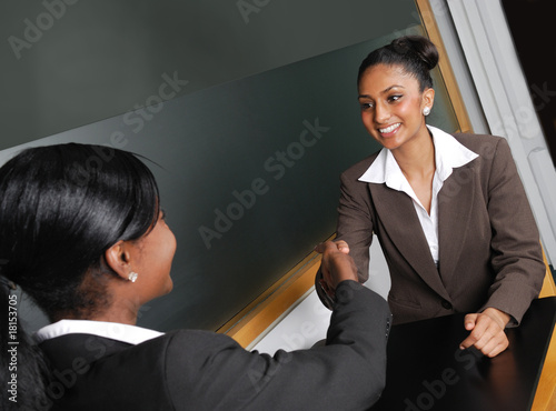 Photo: Multi-ethnic business team discussion with handshake Multi-ethnic business team discussion with handshake