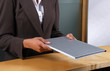 Photo: Asian receptionist handing a book Asian receptionist handing a book