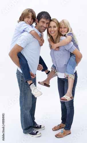 Foto: Family giving children piggyback ride against white Family giving children piggyback ride against white