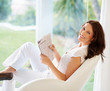 Photo: Portrait of a cheerful woman holding newspaper Portrait of a cheerful woman holding newspaper