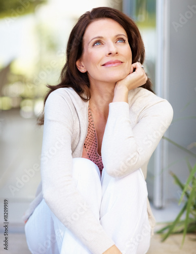 Photo: Mature woman looking away day dreaming Mature woman looking away day dreaming