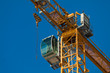 Cab modern construction crane on a background of blue sky