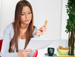 Woman at home reading from notebook Woman at home reading from notebook