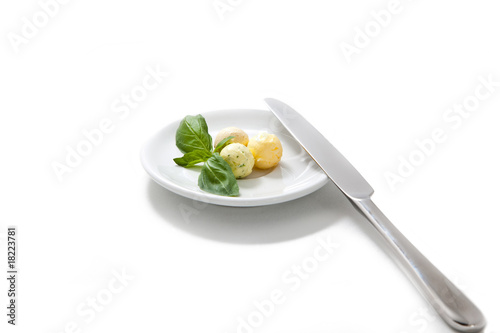 Photo: Three balls from oil, with mint, on a plateau. isolated on the w Three balls from oil, with mint, on a plateau. isolated on the w