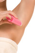 Woman with deodorant stick under her armpit