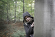 Hiding behind tree