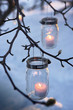 bare branches with sparkling votives in homespun holders