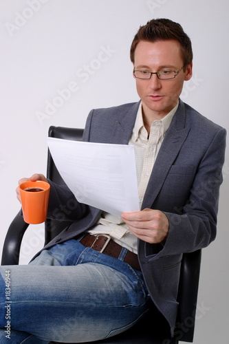 Photo: bisinessman reading paperwork bisinessman reading paperwork