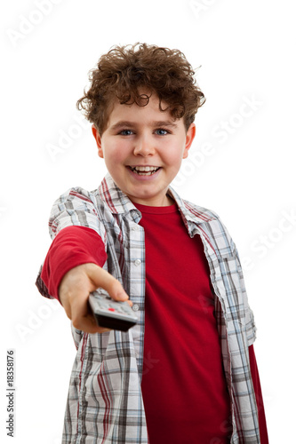 Photo: Boy using remote control isolated on white Boy using remote control isolated on white