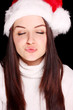 Girl blowing kiss in christmas hat