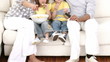 Family on the sofa eating and watching television