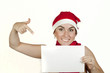 beautiful woman smiles in a New Year's cap and holds white sheet beautiful woman smiles in a New Year's cap and holds white sheet