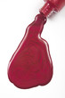 red nail polish splashed on white background