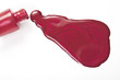 red nail polish splashed on white background