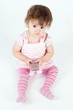 Little girl in pink holding mobile, isolated on white