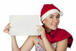 beautiful woman smiles ina New Year's cap and holds white sheet beautiful woman smiles ina New Year's cap and holds white sheet