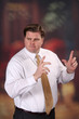 Adult male lecturing or making a point with his hands raised