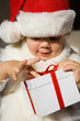 The small child presses to itself a beautiful  gift