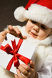The small child presses to itself a beautiful  gift