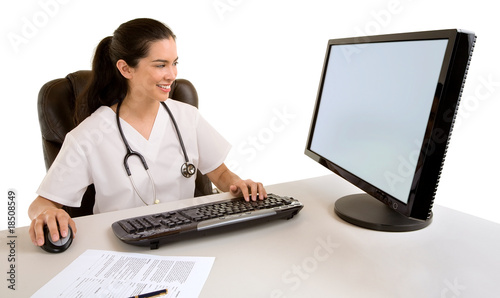 Photo: Nurse Sitting and Working at her Computer Nurse Sitting and Working at her Computer