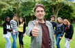 Man with thumbs up outdoors