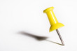 Yellow pushpin macro, isolated on white
