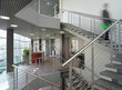 Conterporary office interior. Staircase, mooving people. Speed..