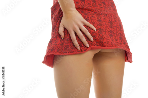 Photo: Woman pulling up her dress. Woman pulling up her dress.