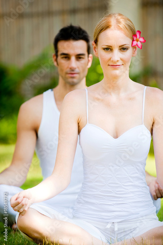 Photo: Couple Practicing Yoga Couple Practicing Yoga