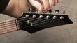 Man sitting and playing electric guitar