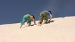 Boys run up by the sand